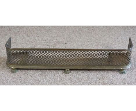 A Regency brass and fretwork fireguard, with paw feet, 24cm high, 120cm wide