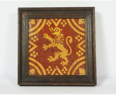 A Flemish slipware decorative tile, 17th century, decorated with a lion rampant within geometric lines and dots, 14 x 14cm