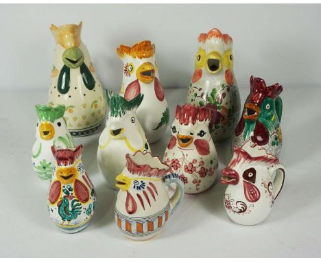 A large assortment of Italian Deruta Majolica pitcher jugs, all with assorted chicken head spouts, decorated in colours, asso