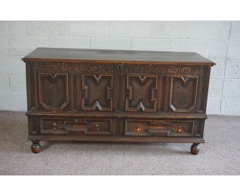 An oak panelled coffer, early 18th century, the hinged top over a fielded panelled front, with carved frieze inscribed 'KB 17