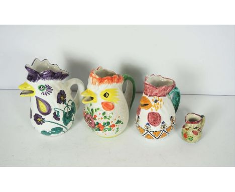 A large assortment of Italian Deruta Majolica pitcher jugs, some marked F.lli Mari Di Pinto A Mano, all with assorted chicken