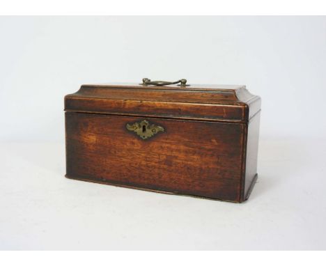 A George III mahogany tea caddy, late 18th century, the hinged lid opening to reveal two tin tea cannisters and a mixing box,