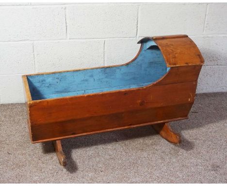 A Victorian child’s rocking cot, 19th century, light blue painted interior, 55cm high, 95cm long