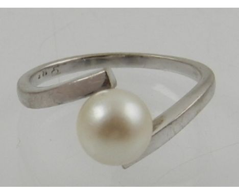 An 18th carat white gold and pearl cross over ring.