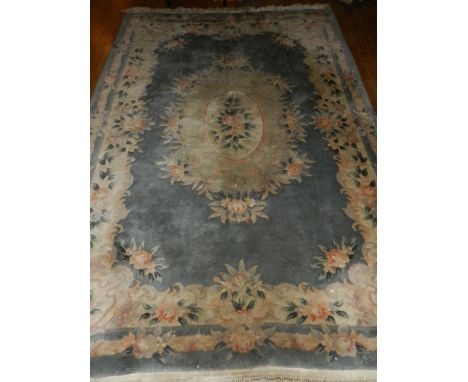 A Chinese blue ground carpet, decorated with floral designs, fringed. L.140cm W.184cm