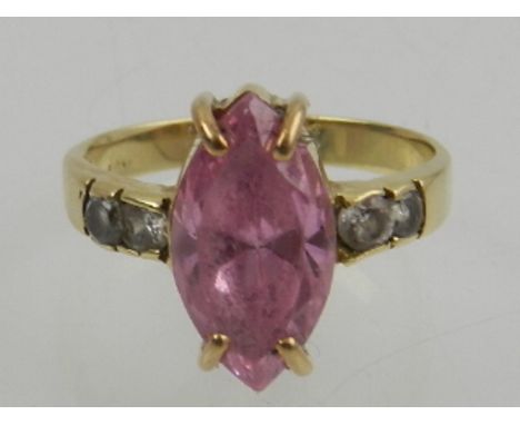 A 9 carat yellow gold, pink and white topaz ring, set with central marquise cut pink topaz, the shoulders set with round cut 
