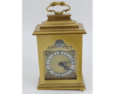 A brass cased mantle clock by Mappin & Webb, the silvered dial set out in Roman numerals, H. 15cm