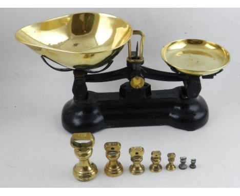 A 20th century set of cast iron and brass weighing scales, together with weights.