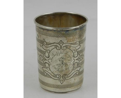 A 19th century Russian white metal beaker, possibly Odessa, decorated with vignette and engraved with German script to centre