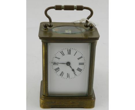 A French brass carriage clock, having corniche case and Roman enamelled dial. H.11cm