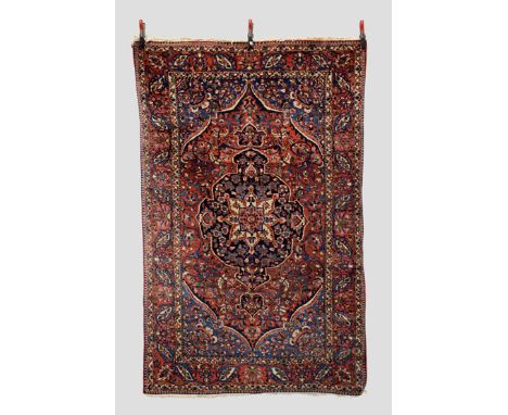 Bakhtiari rug, Chahar Mahal Valley, west Persia, circa 1940s-50s, 7ft. 3in. x 4ft. 7in. 2.21m. x 1.40m. Ivory and dark blue c