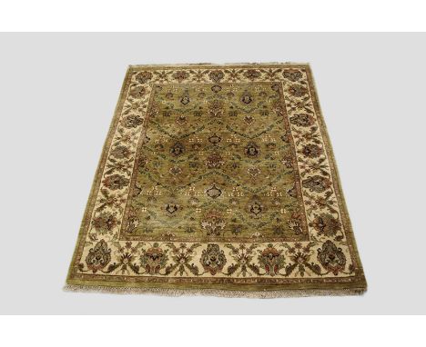 Modern Indian carpet, Jaipur, Rajasthan province, north India, 9ft. 7in. x 7ft. 10in. 2.92m. x 2.39m. Pale green field with a