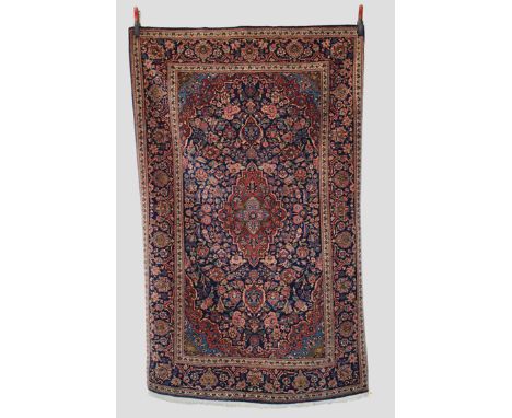 Kashan rug, west Persia, circa 1940s-50s, 7ft. x 4ft. 4in. 2.13m. x 1.32m. Dark blue cartouche shape field with central medal