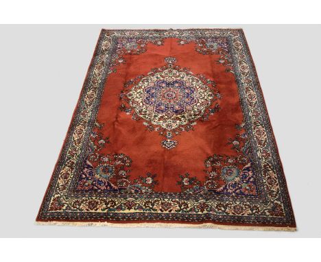 East European(?) carpet, second half 20th century, 10ft. 2in. x 7ft. 3.10m. x 2.12m.  Dark rust/red field with ivory and blue