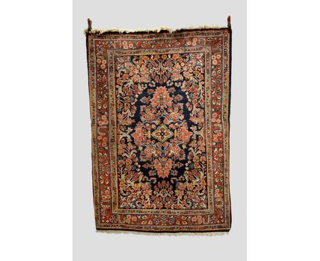Mahal rug, north west Persia, mid-20th century, 7ft. 2in. x 5ft. 2.18m. x 1.52m. Dark blue field with all over flowers and fo