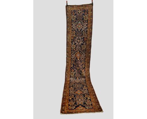 Heriz runner, north west Persia, circa 1920s, 14ft. 6in. x 2ft. 10in. 4.42m. x 0.86m. Slight wear in places; repair/repiled p