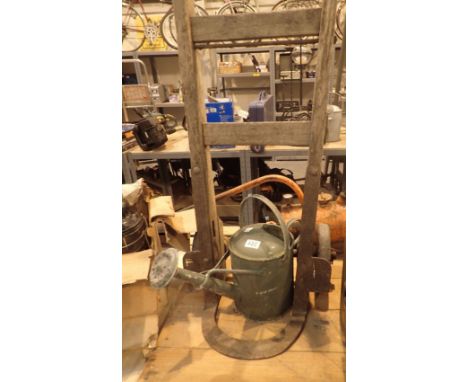Vintage wooden sack or porters truck and a painted green galvanised watering can with rose