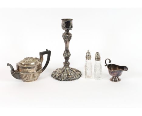 A large plated candlestick,&nbsp;with foliate embossed decoration; two cut glass and plate mounted cruet bottles; a plated te