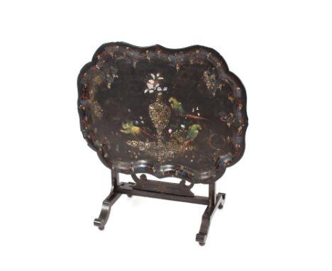 A Victorian papier mache folding tray table, decorated with exotic birds and foliage, heightened in mother of pearl, 74cm wid