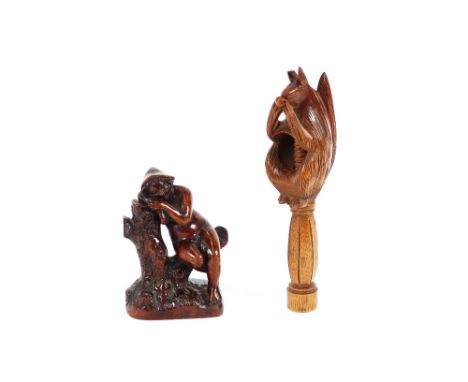 A 19th Century treen nutcracker, carved as a squirrel sitting on a post 19cm long; and a 19th Century hardwood carving of a n