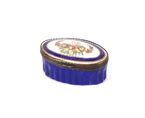 A small 18th Century blue ground Battersea enamel oval snuff box, decorated with flowers and inscribed "A Present from Southw