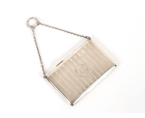 A George V silver card case, with engine turned decoration and monogram, hung to a fine link chain, London 1912