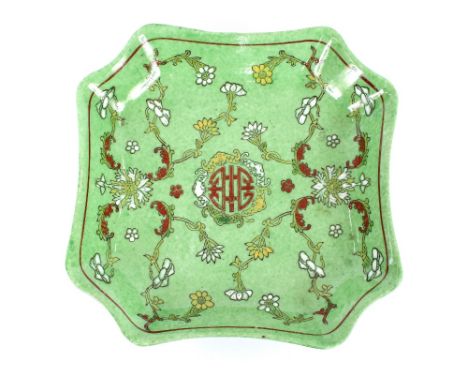 A Chinese green glazed dish, having raised floral decoration, seal mark to base
