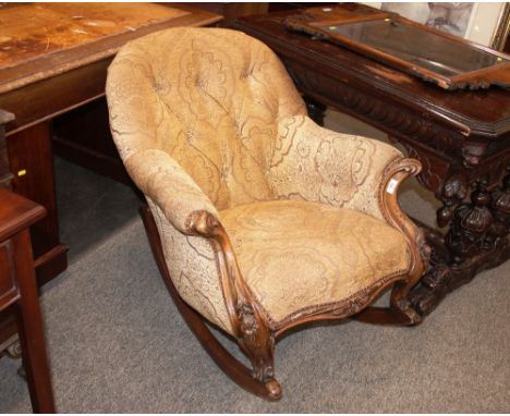 A Victorian walnut framed button back rocking chair, upholstered in floral velour