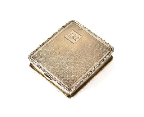 A silver cased travelling watch holder, with engine turned decoration and monogram, containing a timepiece, Birmingham 1927