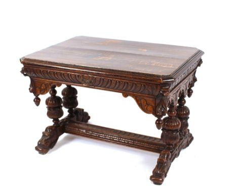 A late Victorian Gothic carved oak side table, fitted with a single drawer above lion masks and foliate scrolls, oak leaf and