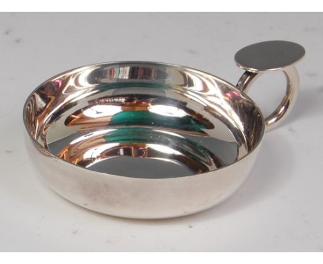 A contemporary silver wine taster, having a thumb-rest ringed handle, of plain circular form, maker Brian Lesley Fuller, Lond