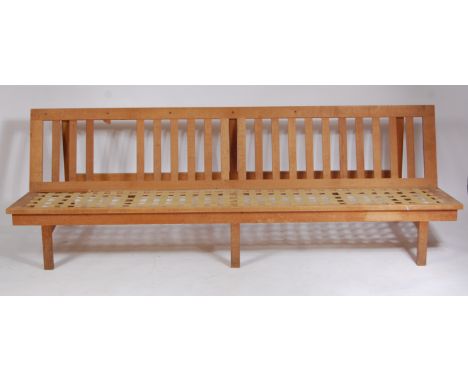 A Borge Mogensen 2219 Fredericia light oak settee, having slatback, webbed seat, and on square cut supports (one slat missing