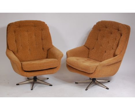 A pair of 1960s Danish chrome framed and light brown fabric buttonback and seat upholstered swivel armchairs, each on five sp