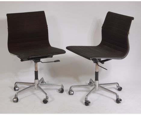 A pair of Charles Eames for ICF aluminium and dark green ribbed hopsack EA108 swivel desk chairs, each having gaslift rise-an