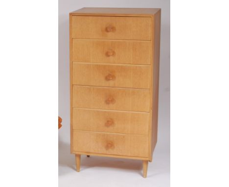 A 1950s light oak squarefront chest of six drawers, having integral turned handles, on further turned supports, h.123.5cm, w.