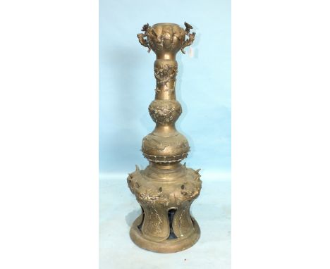 An early-20th century Chinese brass oil lamp base/pedestal of knopped form, applied with dragons, prunus and cranes, the pier