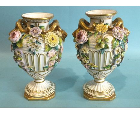 A pair of mid-19th century English porcelain floral-encrusted urn-shaped vases with ram's head handles, cross swords mark ben