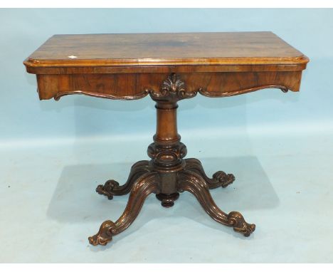 A Victorian rosewood fold-over card table on turned carved column and cabriole quadruped supports, 90cm wide.