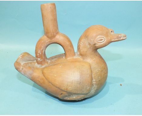 An antique Peruvian or Inca terracotta drinking vessel in the form of a duck, with some original painted decoration, 19cm hig
