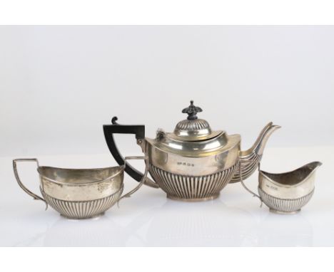 Silver three piece bachelor's tea service, gadrooning to the lower half and finial, ebony angular handle and carved finial, m