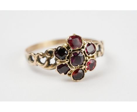 Garnet cluster yellow and rose metal ring, seven cushion cut garnets, claw rubover set, closed back settings, diameter of hea