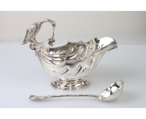 Silver sauce boat, the handle modelled as a stork clutching a snake, the bowl with inverted repoussé sweeping decoration, the