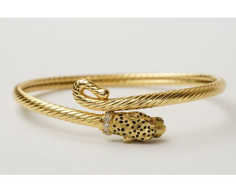 Diamond and ruby unmarked 18ct gold bangle modelled as a leopard head, writhen body and tail, the head with black enamel spot