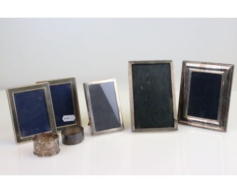 Five small silver easel back photograph frames together with two silver napkin rings (7) 