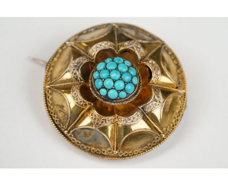 19th century turquoise yellow metal target brooch, fine ropework and filigree decoration, the centre full set with graduated 