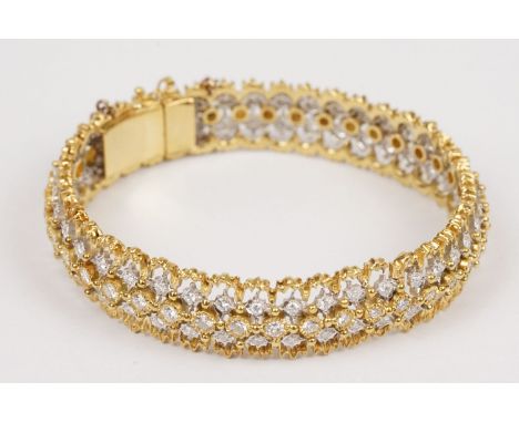 Diamond 18ct yellow and white gold bangle, comprising forty-one small round brilliant cut diamonds to the centre, each weighi