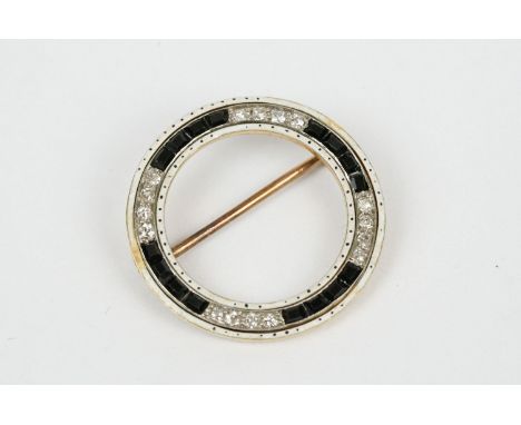 Art Deco diamond and black onyx white enamel unmarked yellow gold brooch, open circular form, total of sixteen small round br