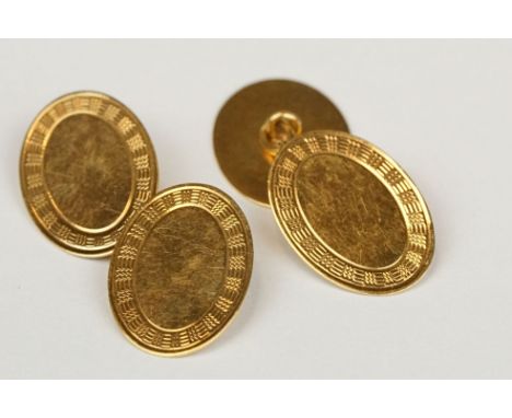Pair of early 20th century 18ct yellow gold chain link panel cufflinks, the oval panels with plain polished centre and chased