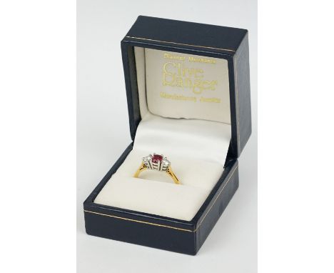 Ruby and diamond 18ct yellow and white gold set three stone ring, the central oval mixed cut ruby measuring approx 5mm x 4mm,