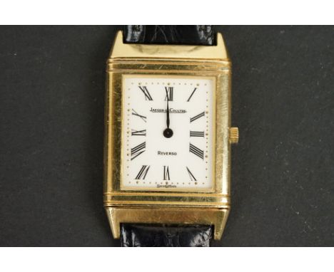Gents Jaeger-LeCoultre Reverso wristwatch ref 140.106.1 with 18ct yellow gold case and buckle.  Black leather strap. 